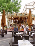 There was also this very fancy carousel complete with some tourists on it!  In front is one of the many cafe's tables you see everywhere in France.