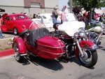 This classic motorbike was the only one with a sidecar. It has a spring seat like the BSA, Dad...

The white car at the back had an impressive white-pearl paint job.