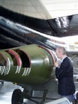 Tim examines the inner of a very large bomb, next to a B52 Bomber one of the biggest planes we've ever seen.  It filled the hangar and all the other planes were fitted in around it!