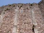 Imposing walls of the castle, which are a very unusual colour almost a purpley-pink.