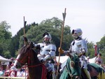 Jousting also gave rise to other sports to hone combat skills from horseback, and included Darts - not the Pub sort - but throwing an oversize dart at a groundlevel target while galloping past.  The knights here are preparing for a run at the target. 