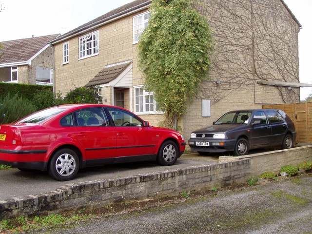 THis is a picture of both the old and the new car parked up our driveway.  The old car now has a cover on it and looks like a big grey heap.  We are still happy with the new car it is very nice.